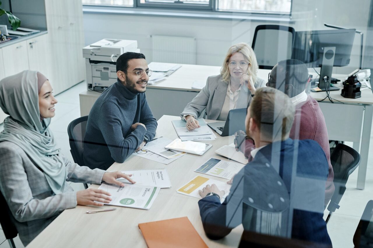 A project team reviewing charts together around a table.