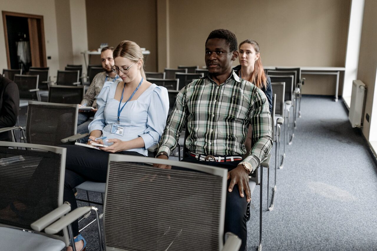 Employees seated and listening during a workplace training session.