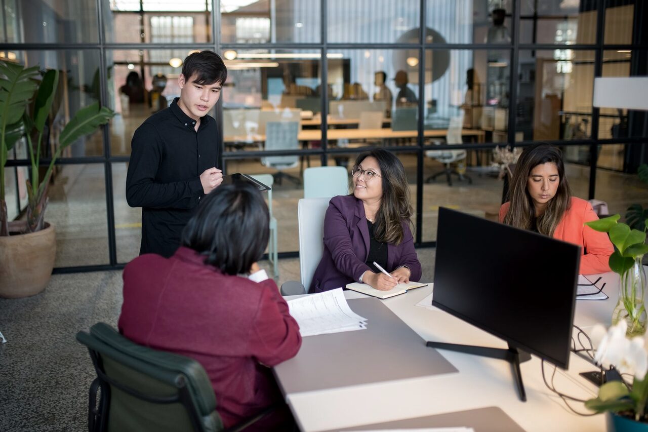 A team working together in a bright open-plan office.